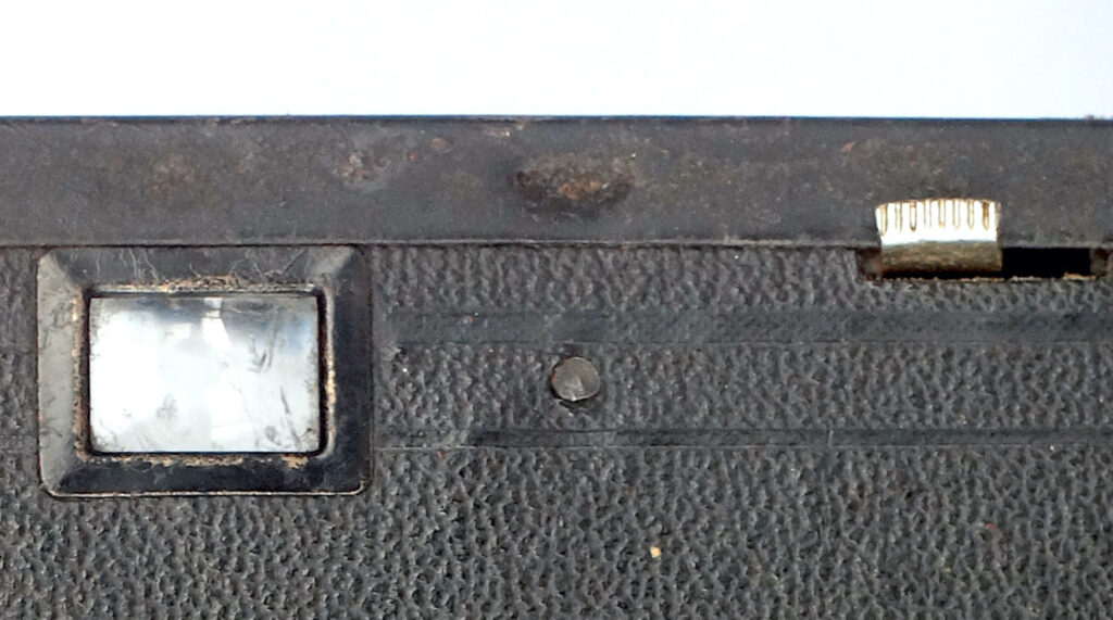 Indent that engages with a slot to fix the front plate.