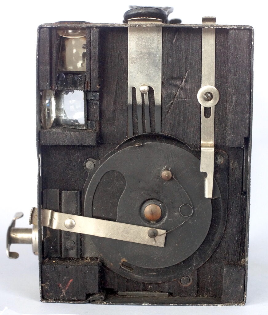 With the front panel removed showing the simple mechanisms and the wood block used to mount them.