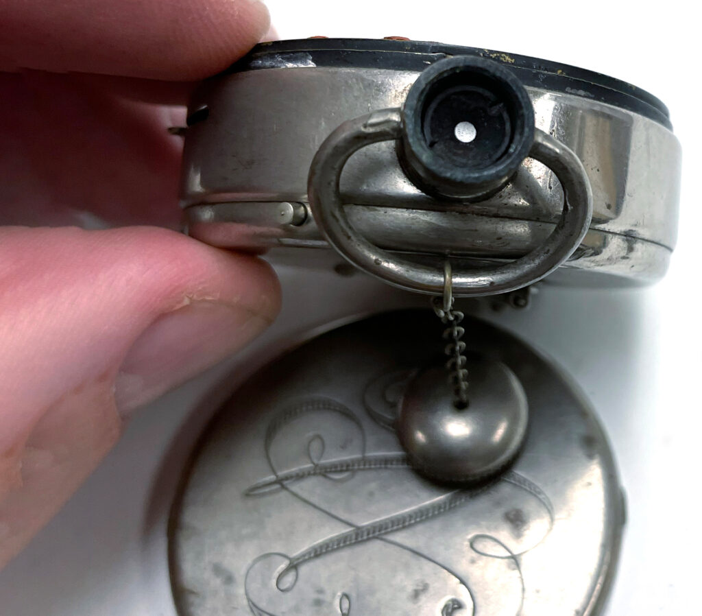 Hand holding Expo Watch Camera so that the lens is shown