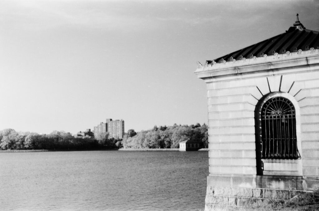 A waterscape in direct sunlight with a small pumping station
