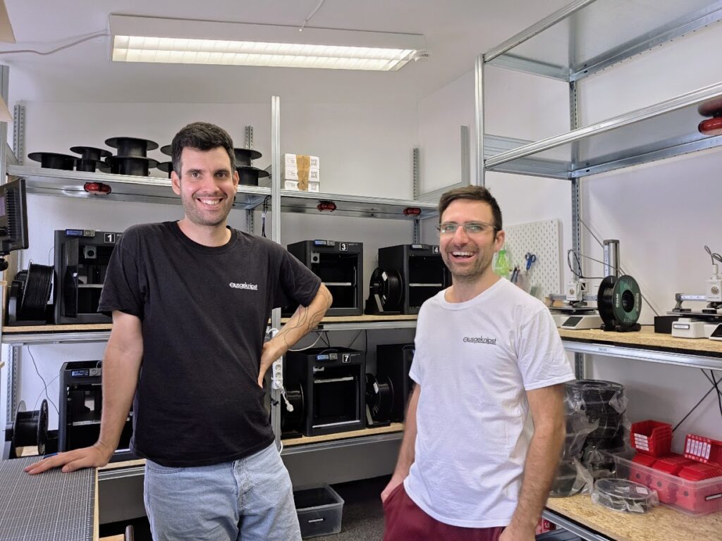 Founders Vladi and Anto in front of our printers.
