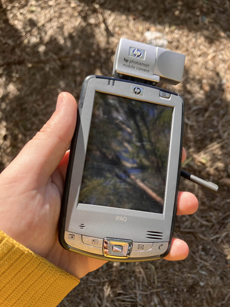 Holding the HP iPaq with camera attachment