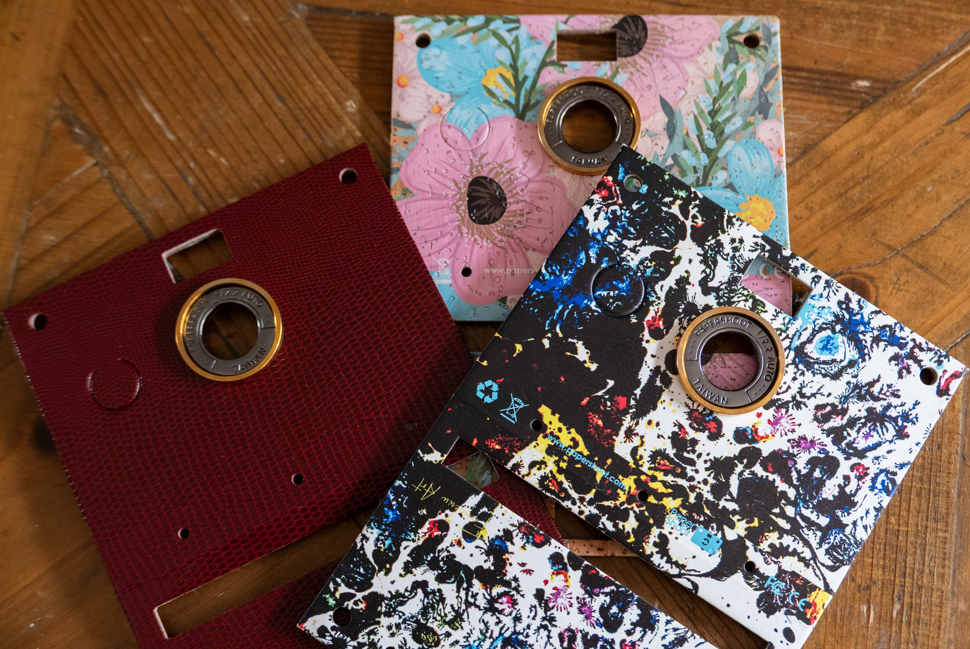 A police van outside a pizza shop, people in the background with obscured faces.