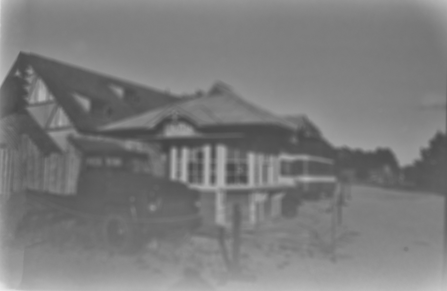 Wheelbarrow of Twigs Behind Fence
