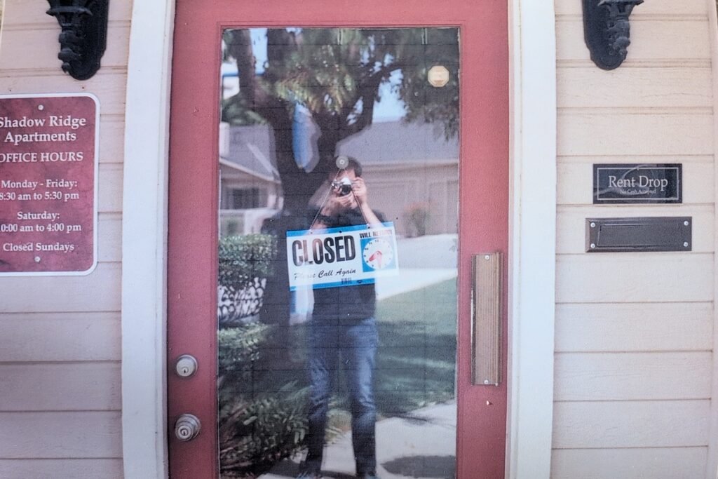 Me reflected in glass door.