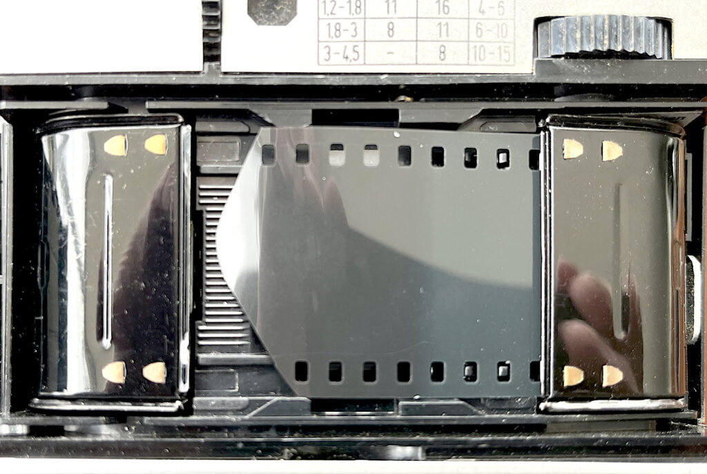 The camera loaded showing the shaped film end. The cops on the feed side are visible.